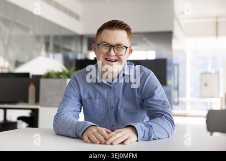 Portrait of smiling man with Down syndrome looking at camera Stock Photo