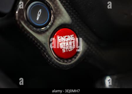 Ferrari 488 Spider start stop button on carbon fiber panel, detail Stock Photo