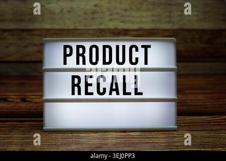 Lightbox with text "Product Recall" on wooden background Stock Photo