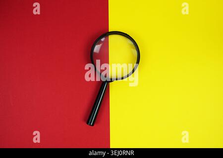 Do's And Don'ts text with magnifying glass on red and yellow  background Stock Photo