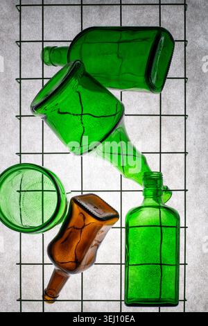 Three green empty bottles on a gray background Stock Photo
