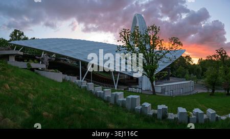 Beautiful clouds in the evening sky above the amphitheater in Szczecin Park Stock Photo