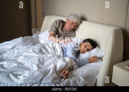 Ignoring stressed senior wife treating elderly husband with coldness and silence after couple brawl. Stock Photo