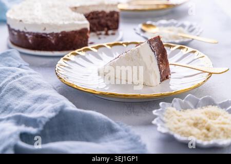Healthy vegan and gluten free chocolate coconut cake on kitchen table Stock Photo
