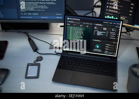 Close up of laptop displaying cybersecurity dashboard and network monitoring data on office desk. Illustrating IT operations, data protection, threat detection, enterprise security Stock Photo