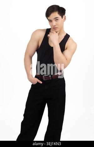 Young man posing with hand on his neck in studio Stock Photo