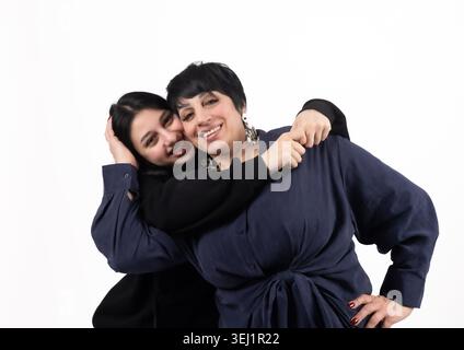 Two young women hugging and laughing together Stock Photo