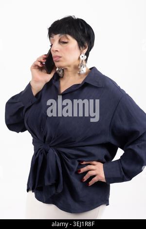 Young woman talking on a smartphone with a serious look Stock Photo