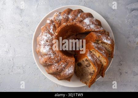 Homemade Cinnamon Walnut Bundt Cake Sliced on a White Plate Stock Photo