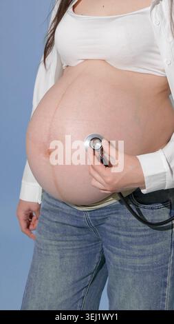 Close up of a stethoscope on a pregnant belly Stock Photo