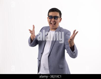 Young man gesturing with hands and smiling Stock Photo
