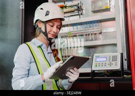 Industry Electrician, Modern technology industrial concept, Expert Engineer electricity technician female worker check inspecting electric wire in ele Stock Photo