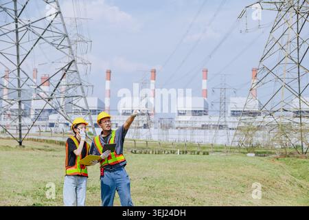 Electricity professional engineer working team against power plant background and power line grid survey inspector Stock Photo