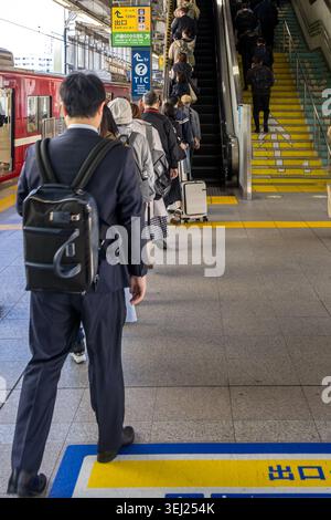 Tokyo, Japan April 16, 2026 commuters lining up at train station exit and escalator in tokyo Stock Photo