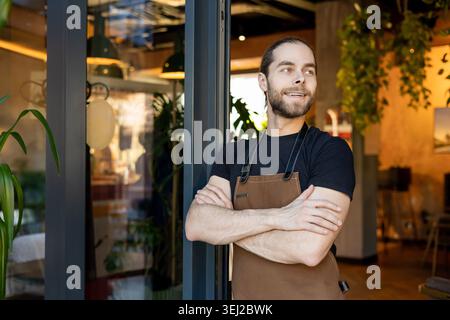 Successful entrepreneur looking away standing in cafe Stock Photo