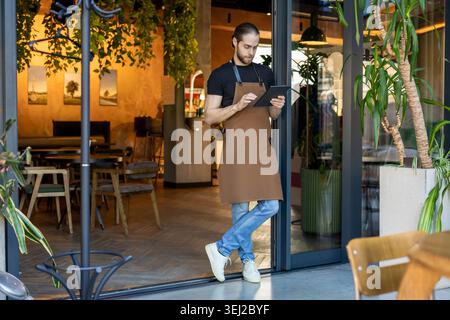 Small business owner checking data on tablet Stock Photo