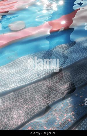 Abstract water reflection background with mosaic stairs inside a blue swimming pool. Stock Photo