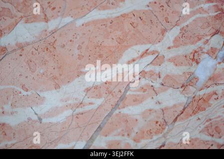 Marble surface with orange and white patterns seen up close Stock Photo