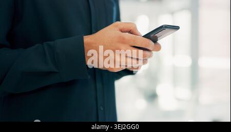 Businessman, hands and texting with phone in office for conversation, social media or schedule. Man, employee or scrolling on smartphone for mobile Stock Photo