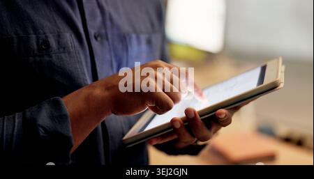 Night, hands and person with tablet in office, planning system maintenance and software development. Tech, overtime and app developer with testing for Stock Photo