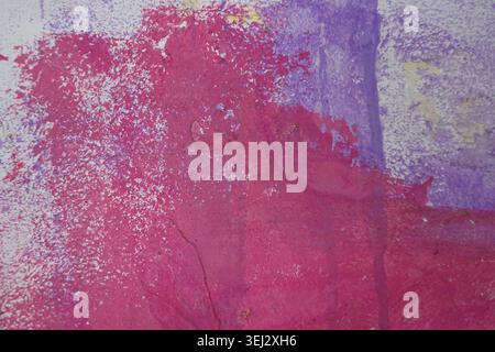 Abstract white painted wall featuring random brush strokes and pink, purple spray background Stock Photo