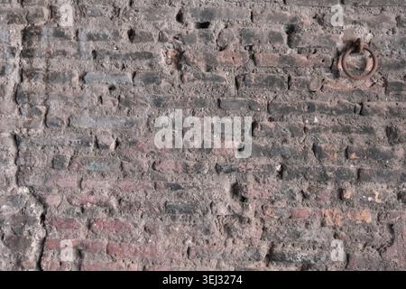 BACKGROUND TEXTURE OF AN OLD BRICK WALL WITH CRACKED PLASTER Stock Photo