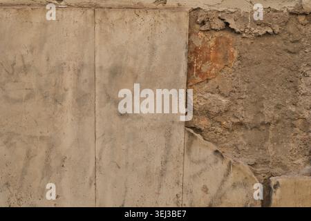 BACKGROUND TEXTURE OF AN OLD BRICK WALL WITH CRACKED PLASTER Stock Photo