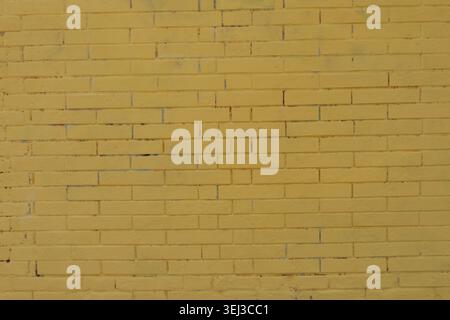 BACKGROUND TEXTURE OF A YELLOW BRICK URBAN WALL Stock Photo
