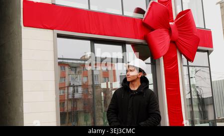 Construction engineer standing near a building with a red ribbon Stock Photo