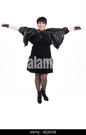Young woman standing with arms spread wide Stock Photo