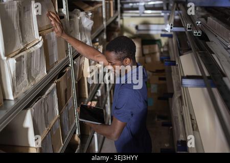 Stock Controller Task Example A worker organizes packages in a storage area at the Leefood factory in ...