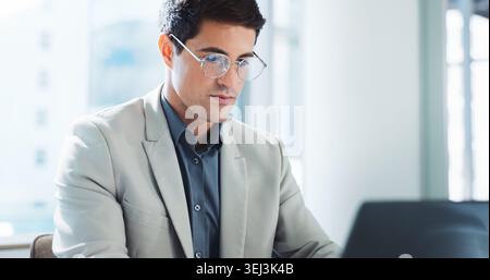 Laptop, serious or business man in office for email, report or compliance officer with project. Computer, reading or accountant work on research for Stock Photo