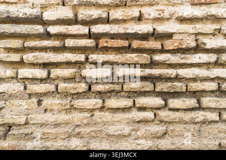 Weathered stained old brick wall background Stock Photo