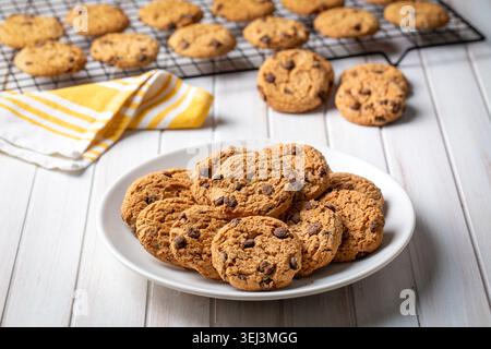 Freshly Baked Chocolate Chip Cookies on a Plate with Cooling Rack and Napkin Stock Photo