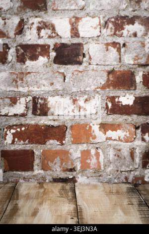 Wooden table top with Red brick wall background Stock Photo