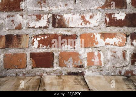 Wooden table top with Red brick wall background Stock Photo