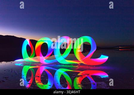 Light Painting Rainbow Reflection at Badwater Basin Blue Hour in Death Valley Stock Photo