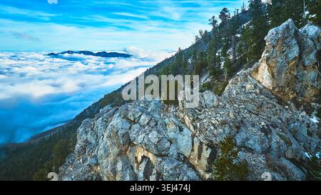Aerial Mt Charleston Rocky Ridge and Forest Above Clouds Nevada Stock Photo