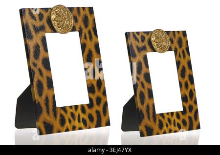 Two photo frames with leopard pattern decoration on white reflective background Stock Photo