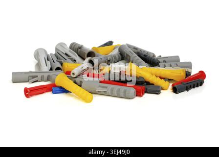 Blue, red, yellow and white plastic dowels on a white background Stock Photo