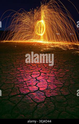 Steel Wool Light Painting Over Cracked Desert Lake Bed at Night Nevada Stock Photo