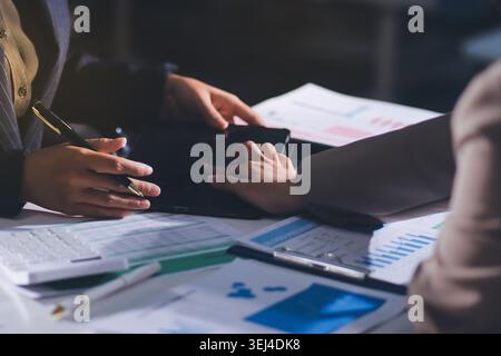Accountants processing financial documents and taxes, managing corporate finance in a modern office. Audit and taxes in business Stock Photo