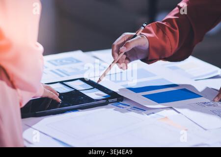 team of UI UX web designer are working together to develop mobile responsive websites with UI UX front end designer previews Stock Photo