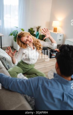 Influencer posing for content creator during home photoshoot Stock Photo