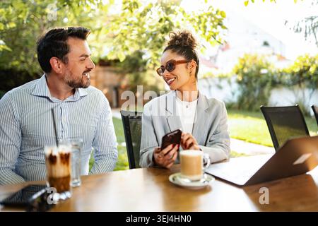 Professionals having business meeting at outdoor cafe Stock Photo