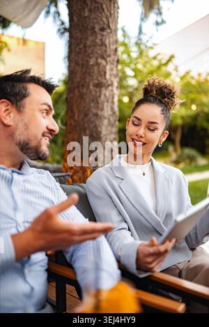 Business colleagues collaborating outdoors during an informal meeting Stock Photo