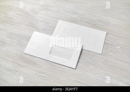 Photo of two blank paper envelopes on light wooden background. Back and front Stock Photo