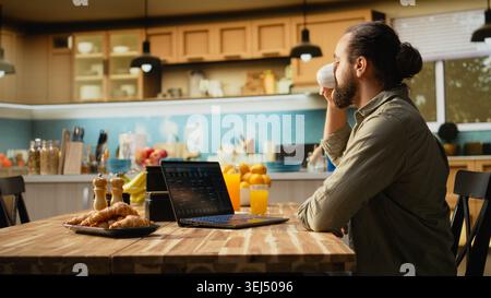 Man focused on programming and software development tasks. Laptop screen displays code, scripts and binary data, illustrating system maintenance and remote work in a high-tech occupation. Stock Photo