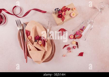 Process of decorating festive autumn table setting with dried flowers Stock Photo