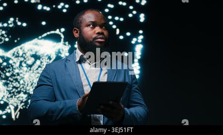 Optimizing neural network, tablet and computer scientist using AR simulation neurons map. Fine tuning AI model, device and African american man adjusting machine learning synaptic weights, camera B Stock Photo